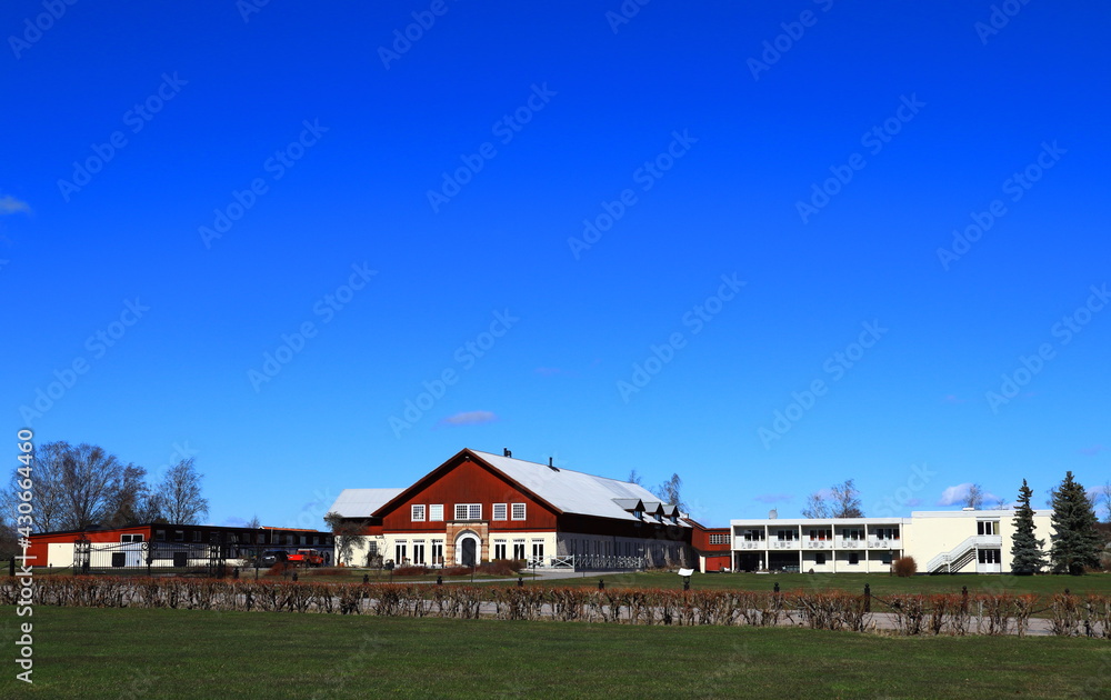 Nice landscape photo with red and white buildings. Great green lawn and a clear blue sky. No clouds. Outside a sunny spring day. Skokloster, Håbo, Uppsala, Sweden, Europe. Nice landscape photo with red and white buildings. Great green lawn and a clear blue sky. No clouds. Outside a sunny spring day. Skokloster, Håbo, Uppsala, Sweden, Europe.