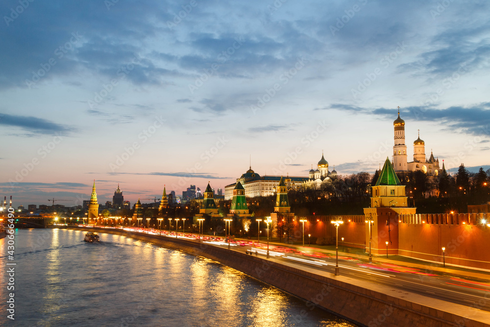 The Moscow Kremlin in sunset. Bell tower. Embankment. Car traces