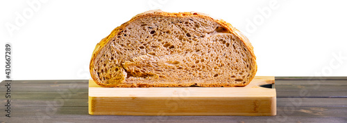 Rustic Cereal Bread cut on wooden cutting board on the table, still life big whole grain bread photo
