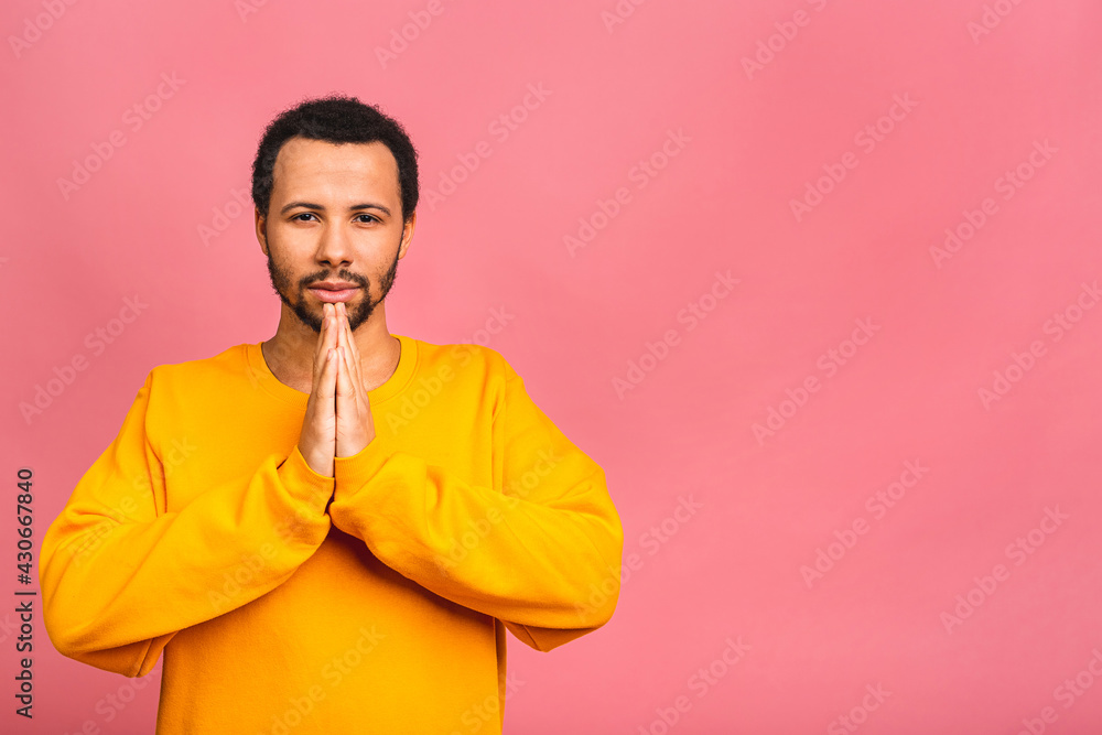 African american man wearing casual standing over isolated pink background begging and praying with hands together with hope expression on face very emotional and worried. African american man wearing casual standing over isolated pink background begging and praying with hands together with hope expression on face very emotional and worried.