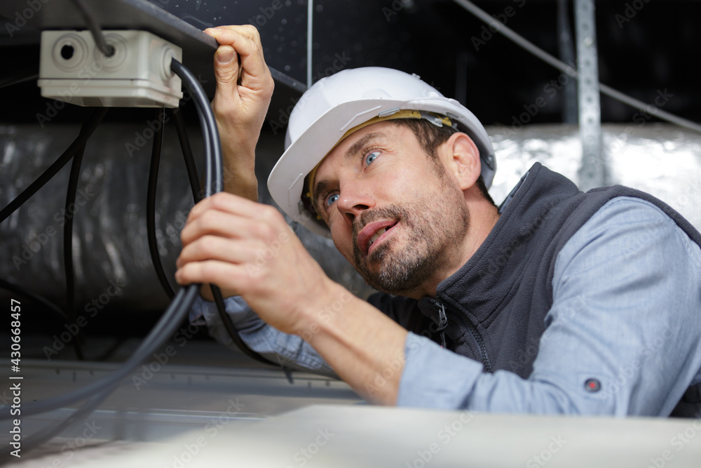 electrician fixing neon on the ceiling electrician fixing neon on the ceiling