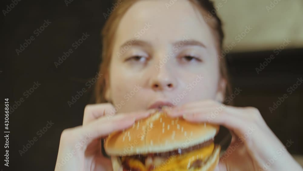Young woman bites fun at the burger. Young woman bites fun at the burger.