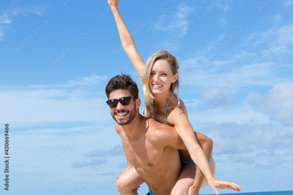 a happy couple playing at beach a happy couple playing at beach