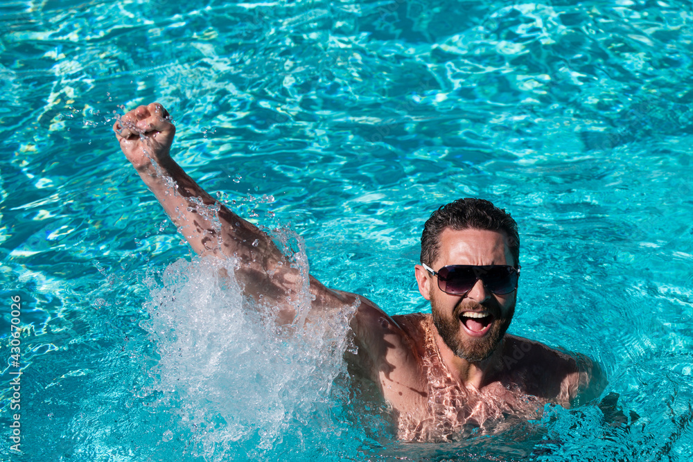 Life winner. Handsome man in swimming pool. Pool party. Summer resort.