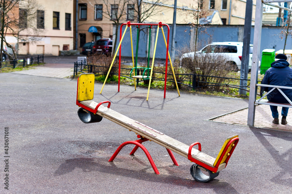 Swing against the background of the playground in the courtyard of condominium Swing against the background of the playground in the courtyard of condominium