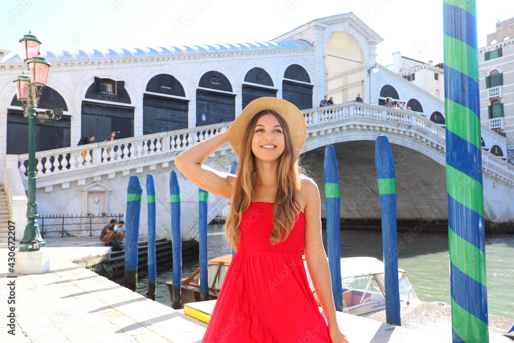 Smiling tourist girl with red dress in Venice, Italy