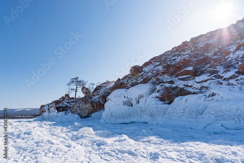 Ice-covered Burkhan Cape of Olkhon Island in the Maloye More Bay of Lake Baikal in winter. Siberia, Russia photo