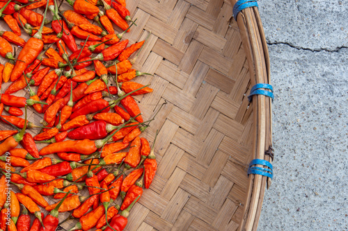 Dried chilies in a woven basket.