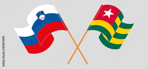 Crossed and waving flags of Slovenia and Togo