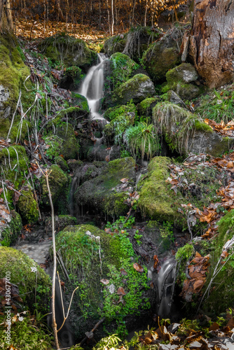 Small spring creek with green moss stones in Jizerske mountains