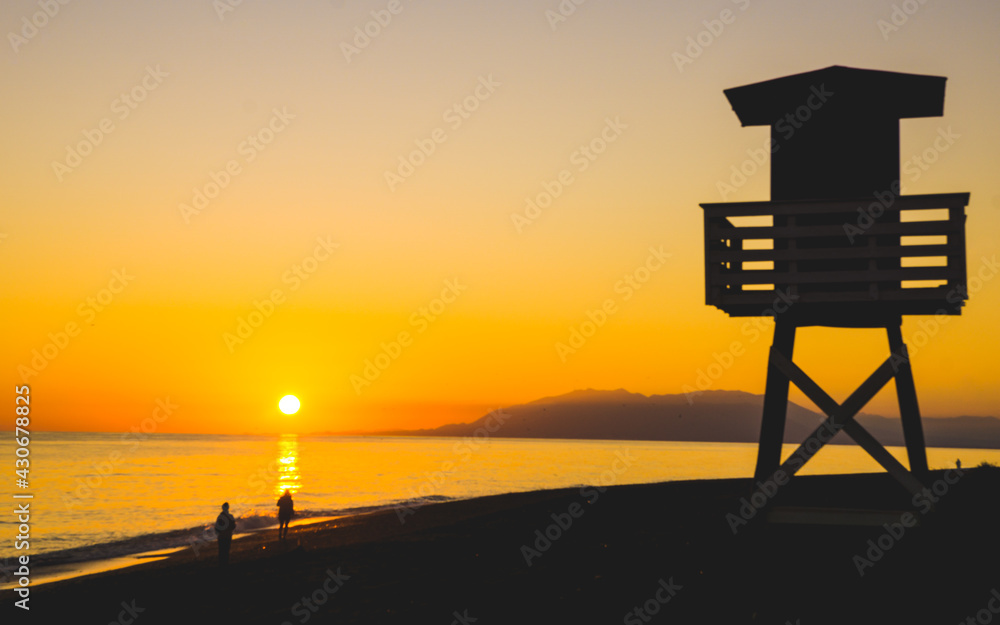 The ocean rescue lifeguard tower of the beach of Torre de Benagalbon, a coastal town of Andalucia in Spain at sunset The ocean rescue lifeguard tower of the beach of Torre de Benagalbon, a coastal town of Andalucia in Spain at sunset