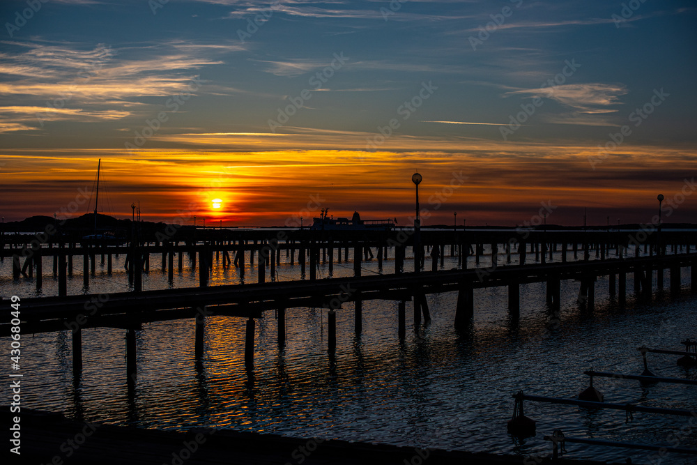 Sunset behind empty wooden piers..