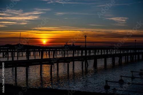 Sunset behind empty wooden piers..