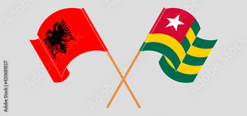 Crossed and waving flags of Albania and Togo