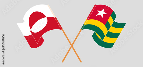 Crossed and waving flags of Greenland and Togo