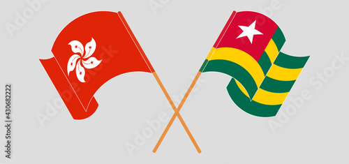 Crossed and waving flags of Hong Kong and Togo