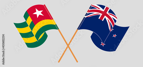Crossed and waving flags of Togo and New Zealand