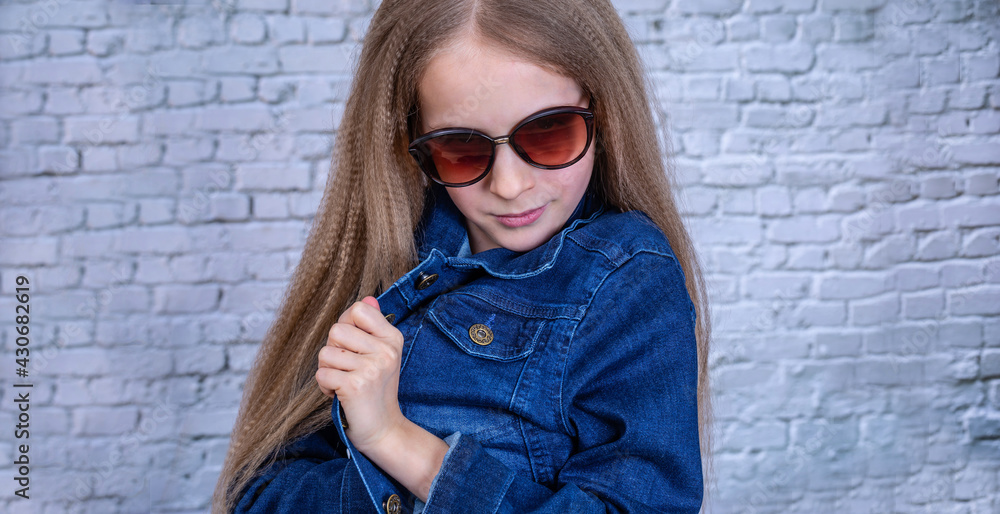 Emotional girl in blue denum jacket looking to the camera. Emotional girl in blue denum jacket looking to the camera.