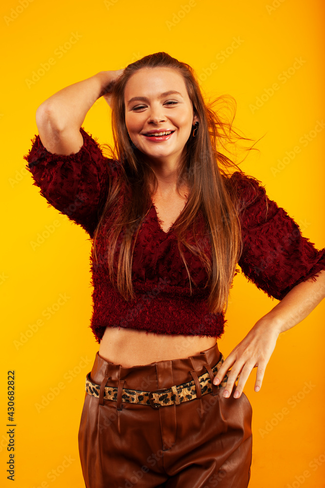 young pretty woman posing in fashion style on yellow background, lifestyle people concept young pretty woman posing in fashion style on yellow background, lifestyle people concept
