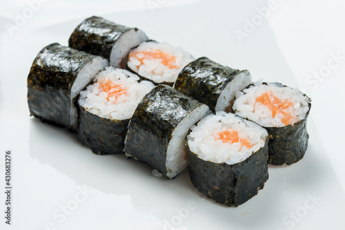 sushi rolls with salmon wrapped in nori leaf isolated on white background