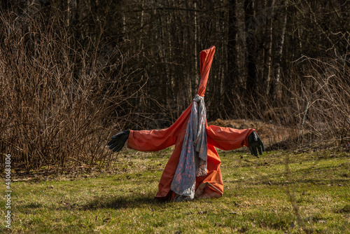 Orange scarecrow in a garden..