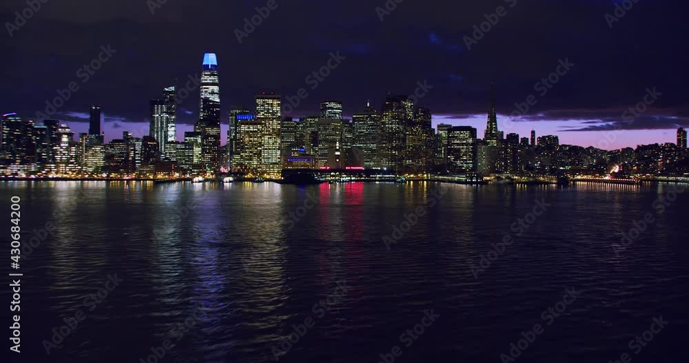 Amazing aerial view of San Francisco skyline. Flyover the Pacific Ocean. Famous skyscrapers over a night sky. Shot in 8K. California, United States. Amazing aerial view of San Francisco skyline. Flyover the Pacific Ocean. Famous skyscrapers over a night sky. Shot in 8K. California, United States.