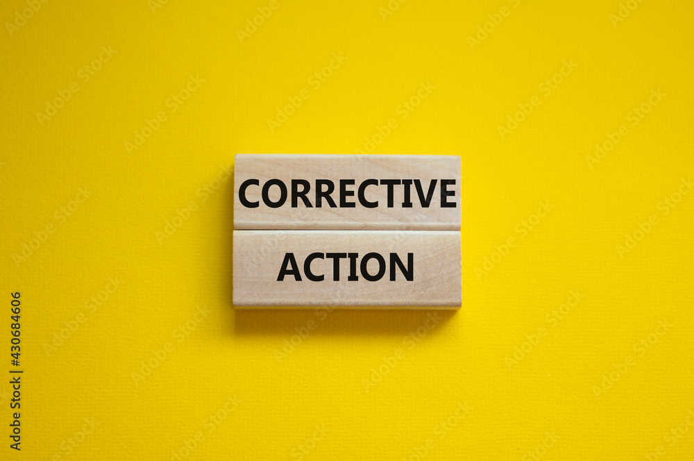 Corrective action symbol. Wooden blocks with words 'Corrective action