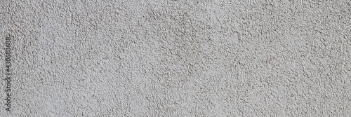 Texture of a plastered wall. Rough surface. Wide panoramic texture for background and design.