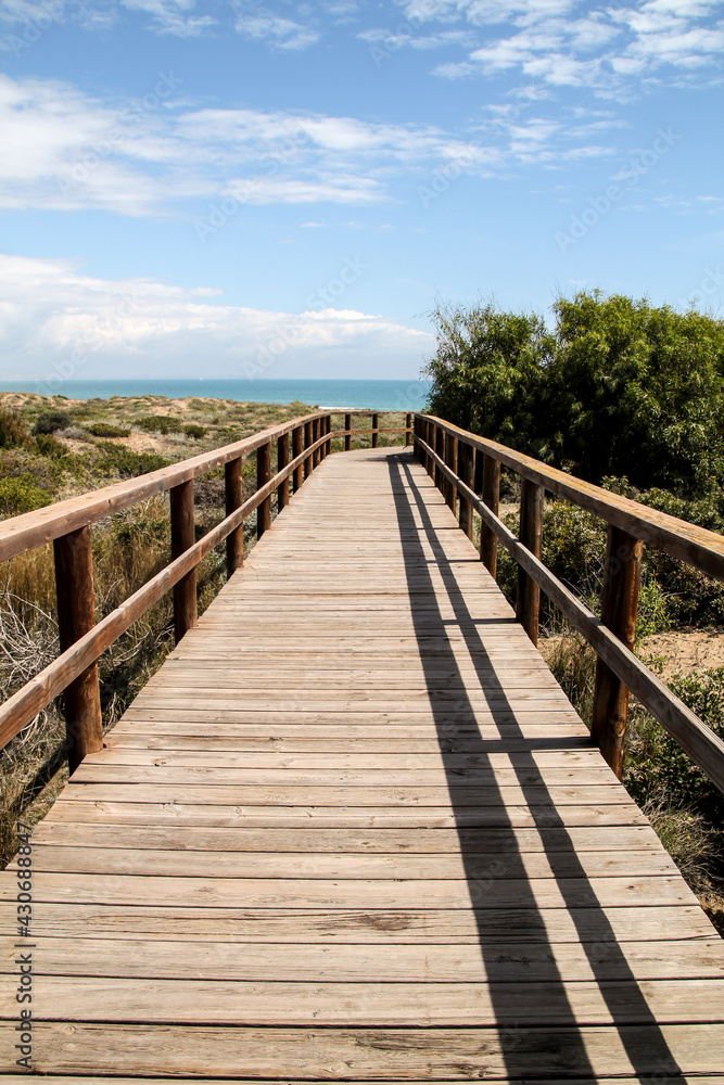 Wooden walkway to the beach in the morning in Spain