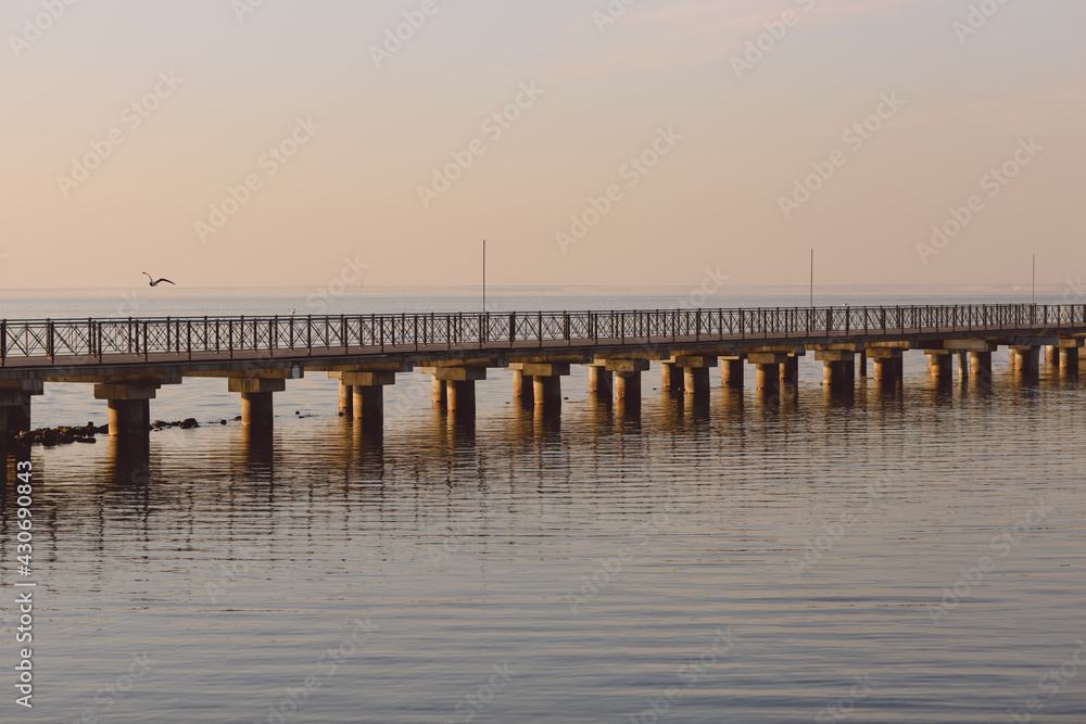 Marine pier for boats and yachts against the backdrop of the sunset. The Gulf of Finland.