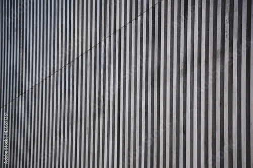 Vertical striped, dark metallic texture of the building.