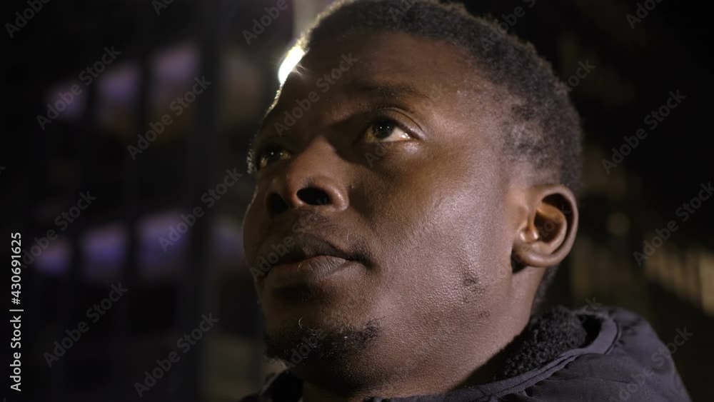 faith, hope - young sad black man in the street at night looks up for comfort faith, hope - young sad black man in the street at night looks up for comfort
