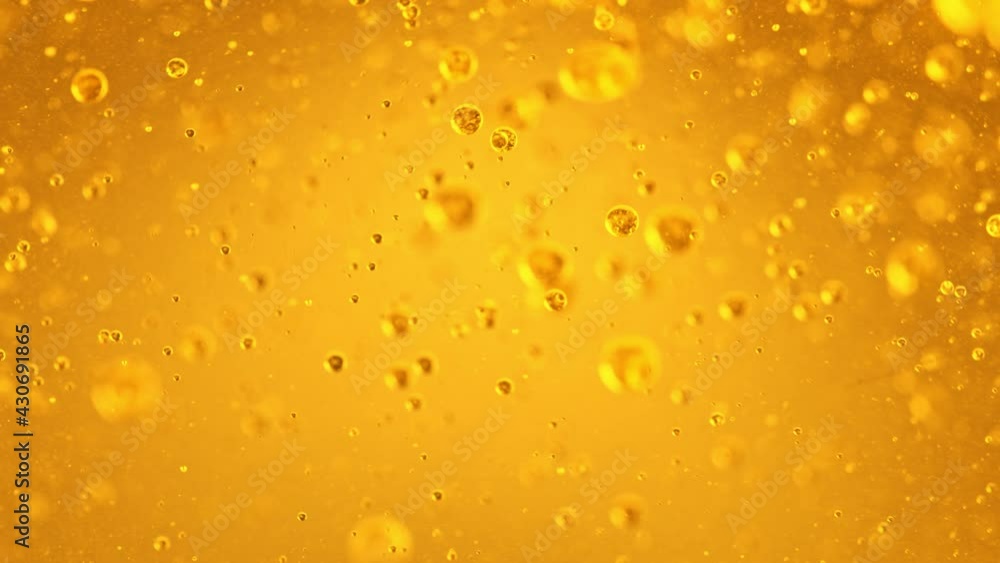 Super Slow Motion Shot of Moving Oil Bubbles on Golden Background at 1000fps. Super Slow Motion Shot of Moving Oil Bubbles on Golden Background at 1000fps.