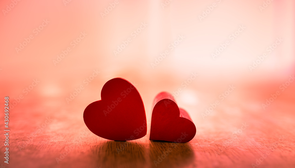 Fototapeta premium Two red hearts side by side. Love, and romance background. 