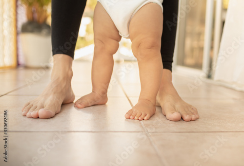 Closeup of mother baby's feet standing. 