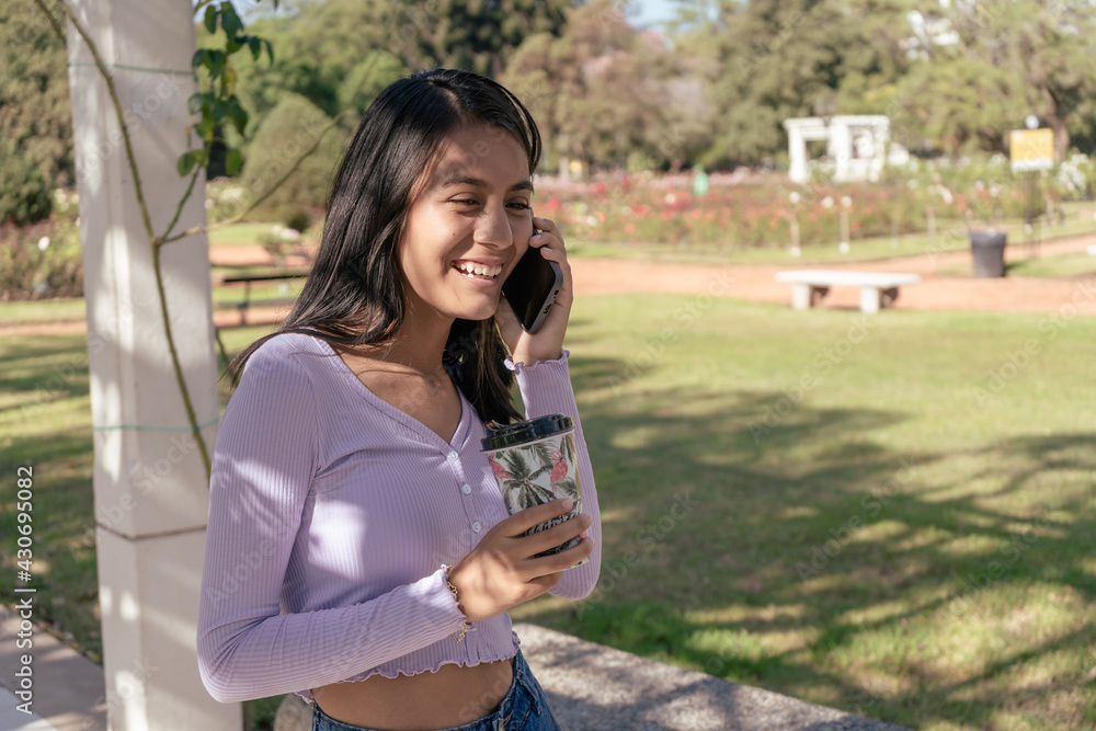 Happy young lady talking on mobile phone. Technology concept Happy young lady talking on mobile phone. Technology concept
