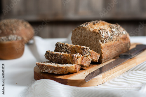 Selective focus. Slices of homemade wholemeal seed bread with a rustic background.