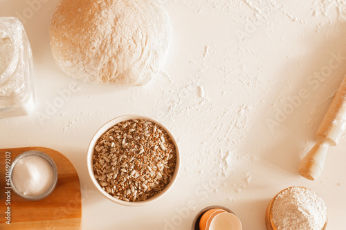 Kitchen table with ingredient to prepare homemade bread. Copy space