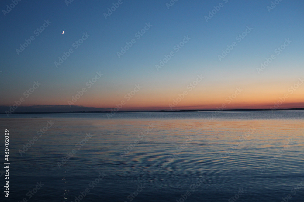 the sea on the water at sunset in the evening on the ocean horizon the sea on the water at sunset in the evening on the ocean horizon