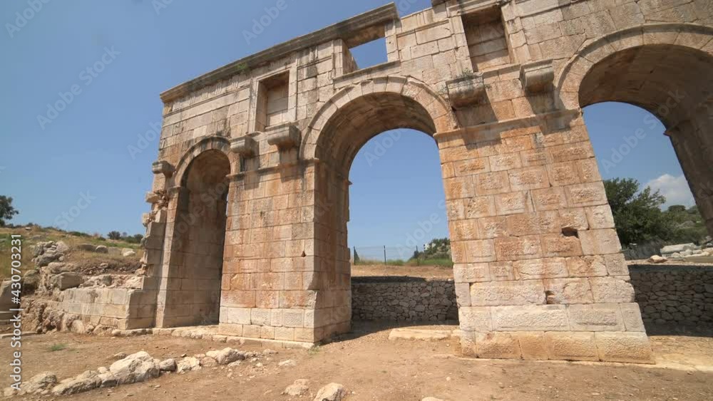 Old historical stone works of ancient civilization city before Christ.Newly discovered and unearthed history ruins at the archaeological excavation site.Patara lycia arch column pillar door temple 4K. Old historical stone works of ancient civilization city before Christ.Newly discovered and unearthed history ruins at the archaeological excavation site.Patara lycia arch column pillar door temple 4K.