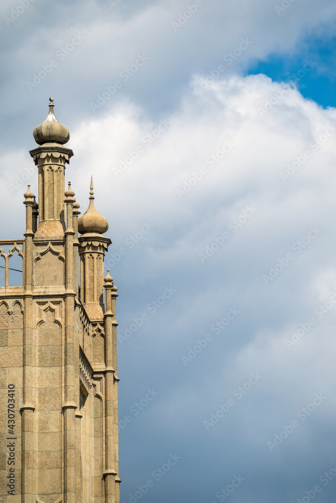 Fototapeta premium The walls and towers of the old palace on the background of a cloudy sky