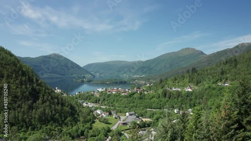 Ascending over dense fir pine trees Showing Vaksdal with road E16 and fjord with view over Osteroy photo