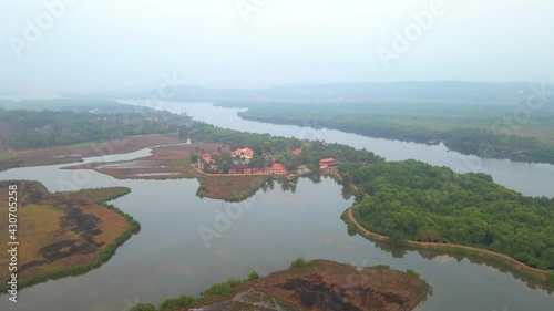 goa divar island drone passing from coconut trees vacation Mercure Goa Devaaya sky reflection on water still water photo