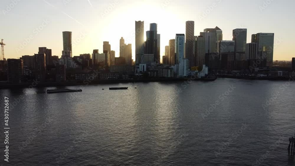 Aerial - Sunset over River Thames and Canary Wharf, London, wide backward shot Aerial - Sunset over River Thames and Canary Wharf, London, wide backward shot