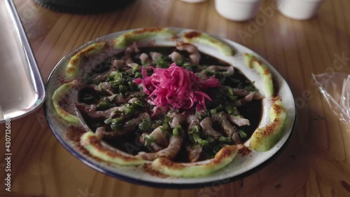 A shrimp aguachile dish from the traditional mexican sinaloan cuisine. Handheld footage. photo