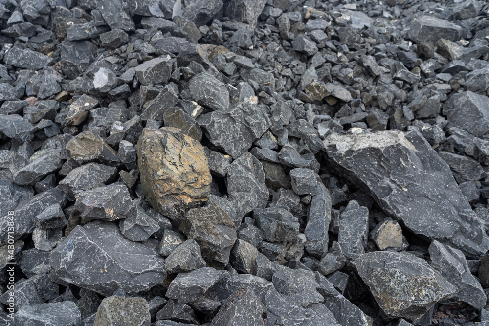 A pile of black pebbles in the construction site. A pile of black pebbles in the construction site.