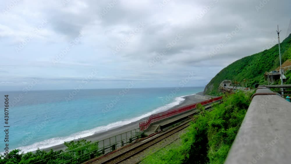 The train tracks are located between the mountains and the sea. The scenery along the Central Cross-island Highway in Taiwan. December 2020. The train tracks are located between the mountains and the sea. The scenery along the Central Cross-island Highway in Taiwan. December 2020.