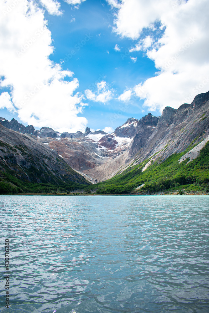 beautiful view of emerald lagoon with mountains in the background beautiful view of emerald lagoon with mountains in the background