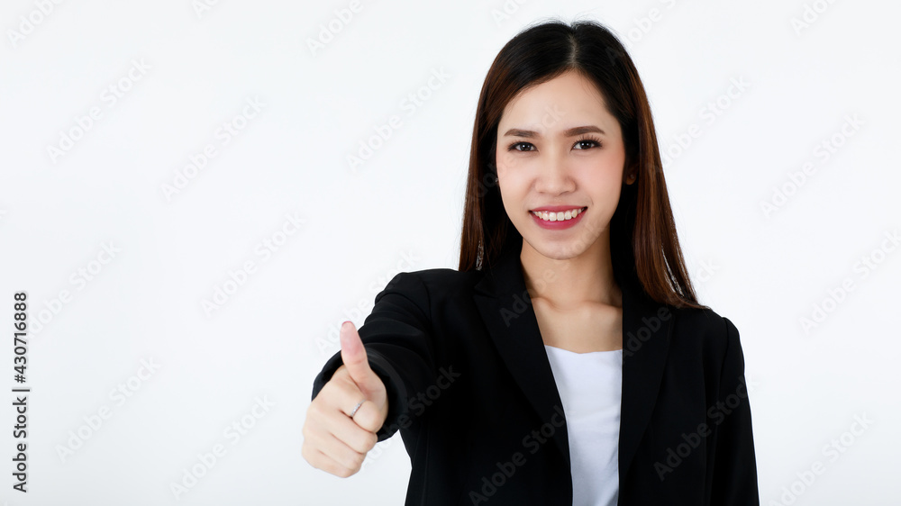 Portrait of an asian beautiful business woman with long hair wearing formal black suit, smiling, pointing and presenting copy space with isolated white background. Portrait of an asian beautiful business woman with long hair wearing formal black suit, smiling, pointing and presenting copy space with isolated white background.
