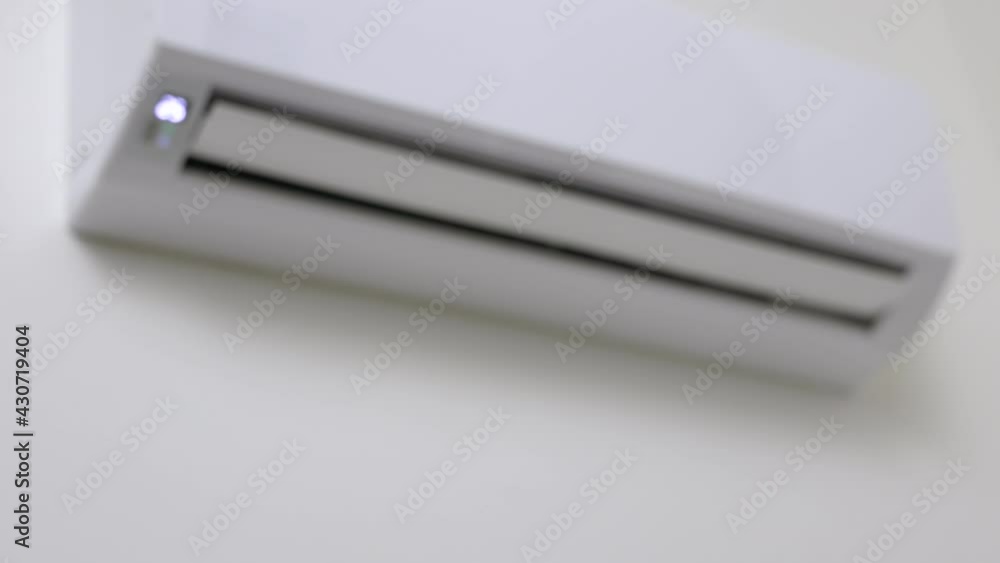 The young man used remote turn on the air conditioning . Adjust the temperature to cool. In the living room at home
The young man used remote turn on the air conditioning . Adjust the temperature to cool. In the living room at home
